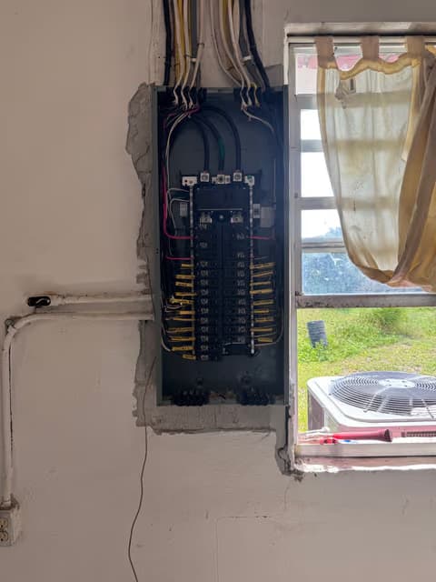 Electrical panel with breakers exposed and wiring run during an upgrade