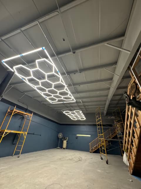 Geometric honeycomb LED light fixture installed on a garage ceiling