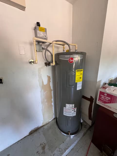 Traditional tank water heater installed in a utility closet