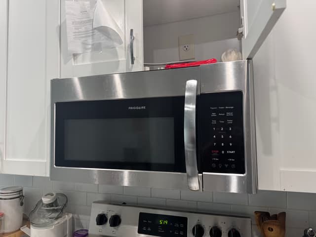 New stainless steel over-the-range microwave installed in a kitchen