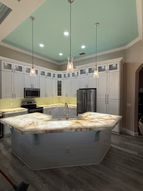 Kitchen with pendant lighting over the island and tile backsplash