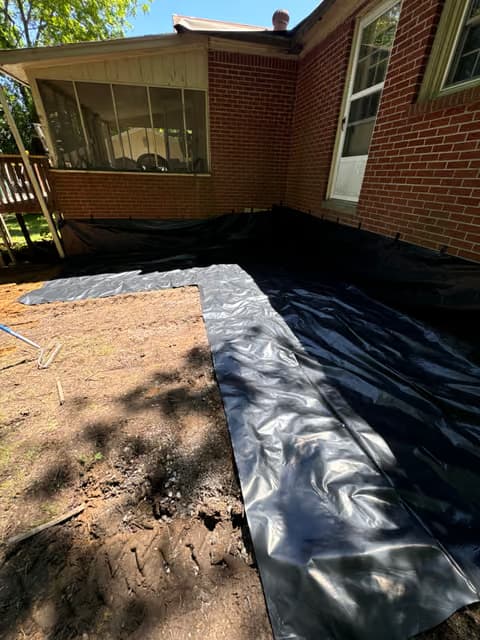 Vapor barrier being laid during a home addition or foundation project