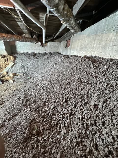 Foundation area with gravel and structural support work in progress