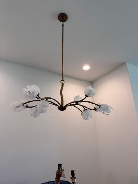Sculptural branch-style chandelier installed in an entryway