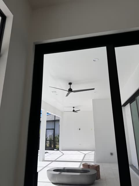 Screened lanai with a new ceiling fan and glass doors