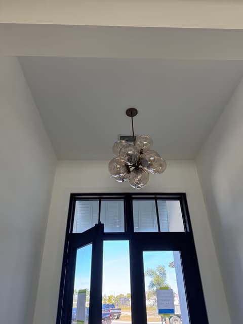 Tall arched window nook with a chandelier installed